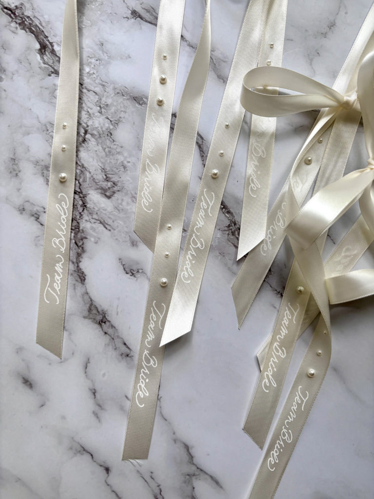 Sanda Letter_Engraver & Calligrapher in Switzerland_HOT FOIL_white ribbons with pearls